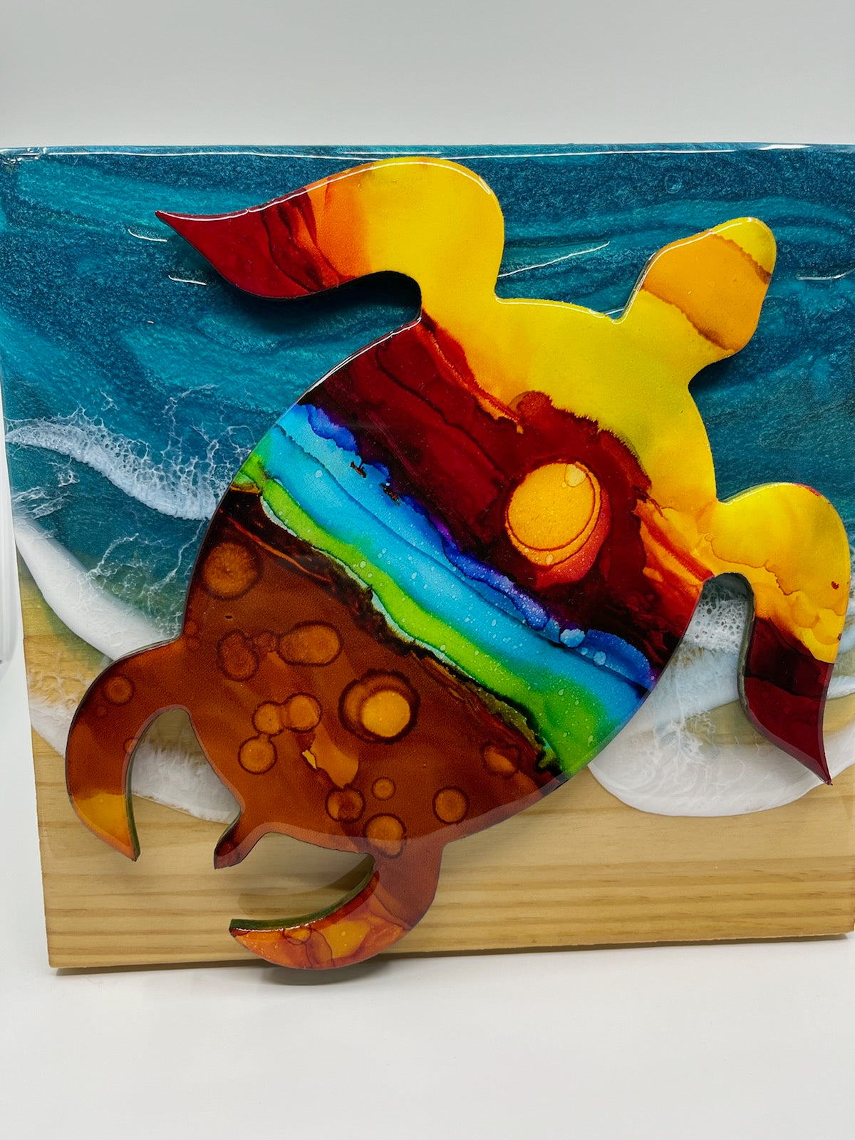 Hand Painted Turtle Art Work By Barbara Newsome. Alcohol Inks on PVC cut out mounted to a wood board with Ocean Resin Waves