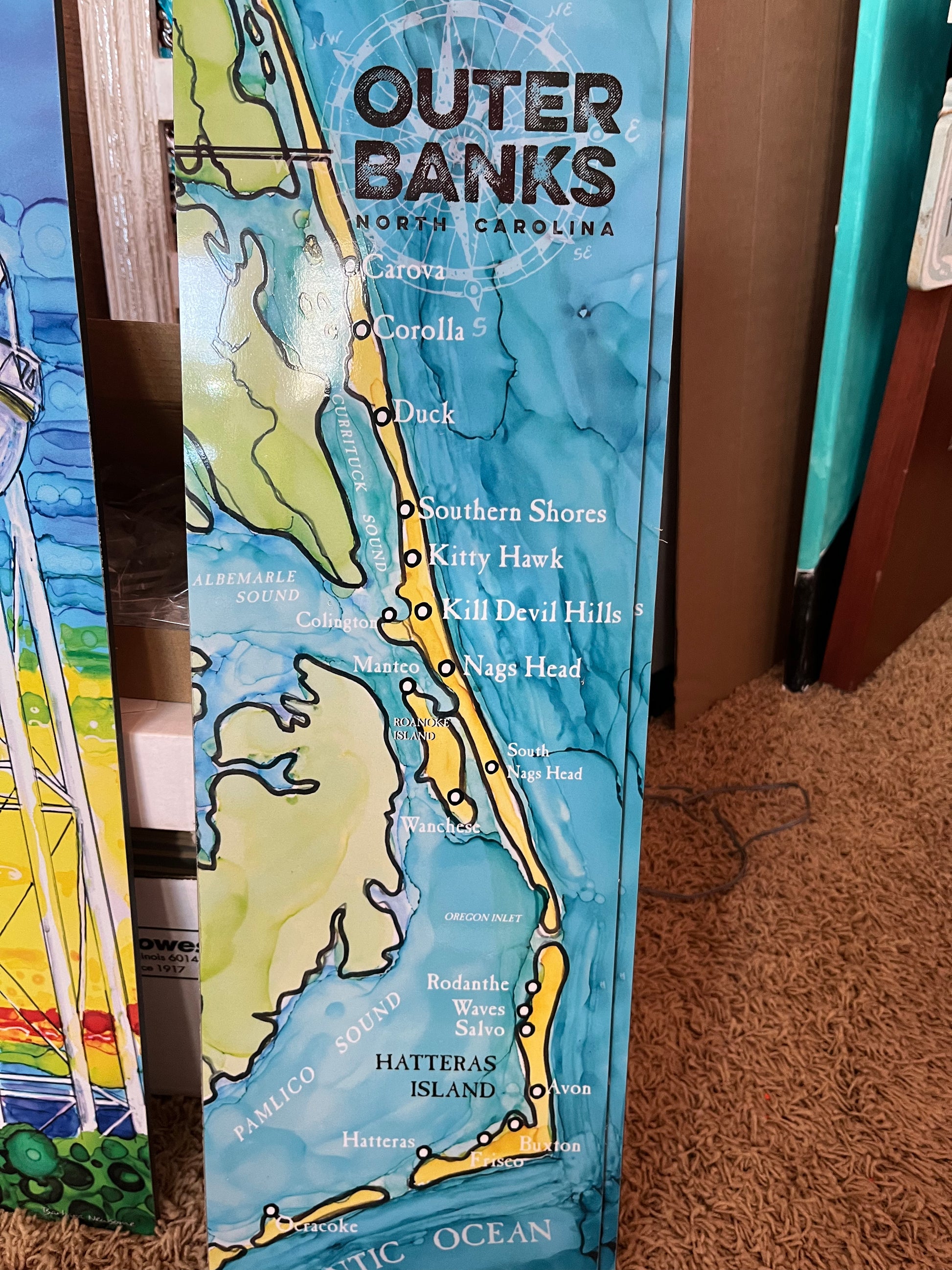 7.25" x 24" Outer Banks Map Print on Metal. OBX Map print from original painting by Barbara Newsome. Graphic map of the coastline of the Outer Banks, North Carolina.