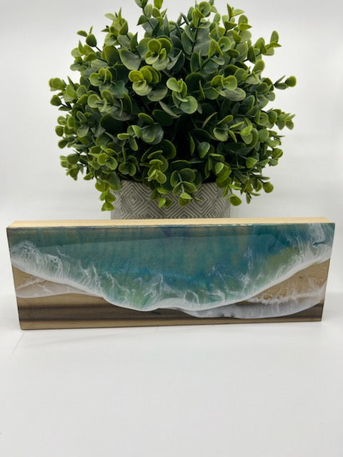 3 1/2" x15" Wood Board with Resin Waves #3. Teal Resin Ocean Waves on wood. Decorate your desk or shelf with this unique piece that will remind you of the ocean.  This is board #3, we have other similar boards, each one is unique.  Display on a shelf or desk our resin art is a reminder of your last visit to the ocean. Hand crafted wooden block resin art by Fyre Art Studio in Kill Devil Hills North Carolina Outer Banks.